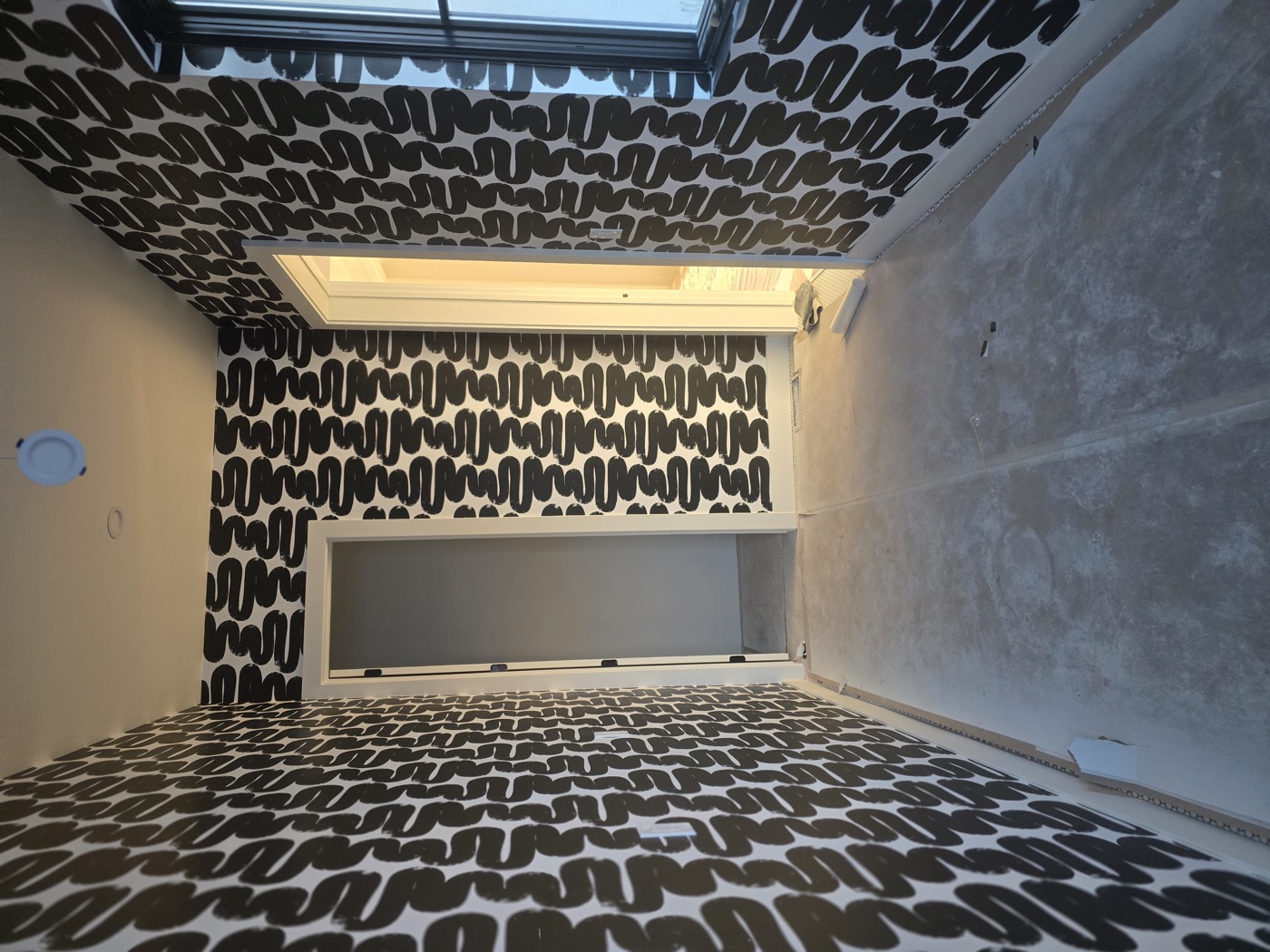 Bold black and white wallpaper installation