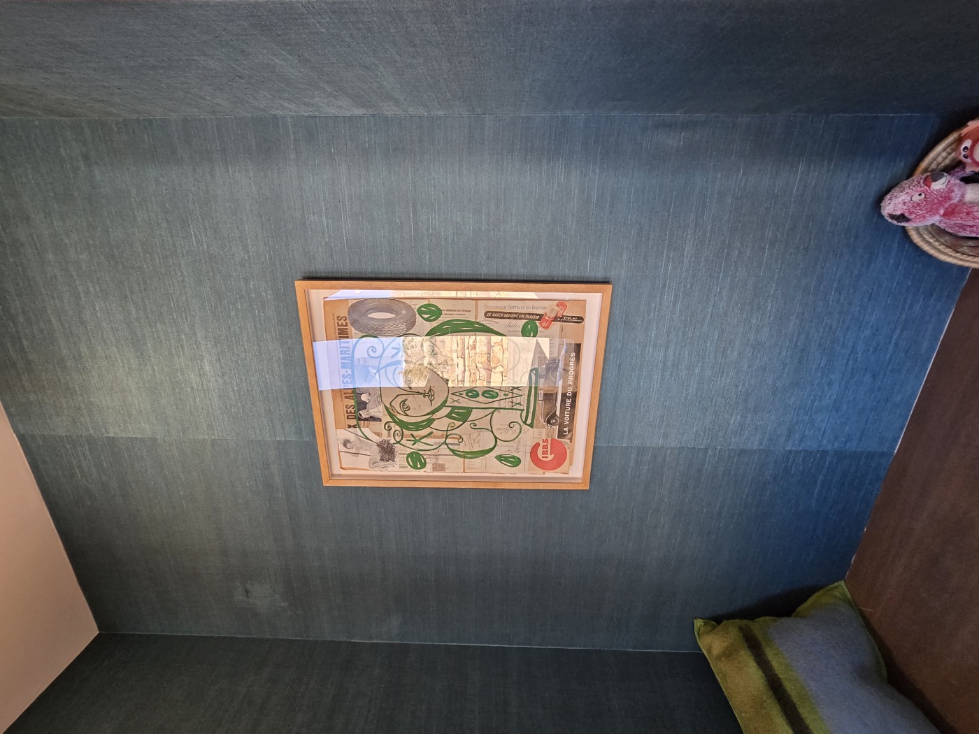 Dark teal grasscloth with framed art