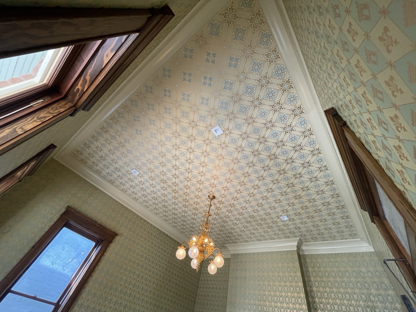 Ornate ceiling wallpaper installation
